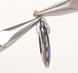 Using pliers to wrap the headpin around the component